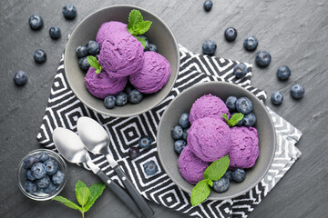 Tasty sorbet with blueberries and mint on black table, flat lay