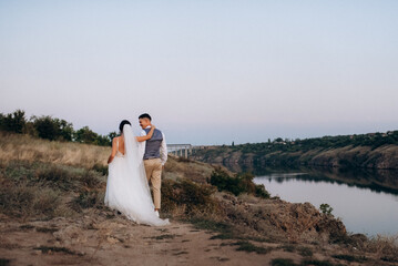 bride girl and groom near the river
