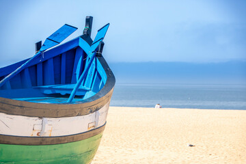 wooden boats on the beach of Nazarè