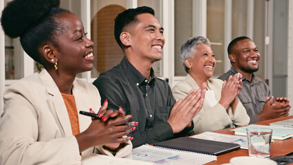 Diverse Group of Professionals Joyfully Applauding During a Business Presentation
