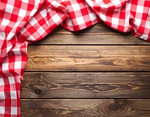 Obraz premium Red and white checkered tablecloth draped artfully on a rustic brown wooden table, creating a charming and inviting scene.