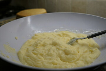 homemade custard in a white bowl with a spoon