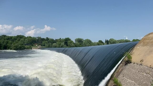 A hydroelectric dam used to generate electricity flows into a river