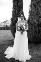 bride blonde girl with a bouquet in the forest