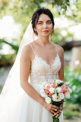 bride blonde girl with a bouquet in the forest
