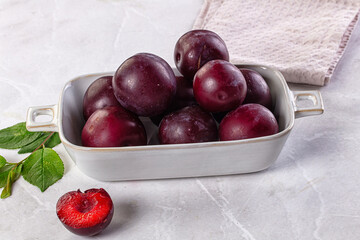 Raw ripe purple plum heap