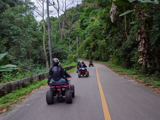 Group of people doing ATV adventure trail in the forest in chiangmai thailand.