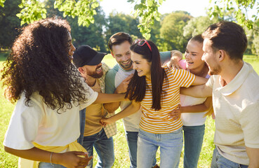 Portrait of a funny happy overjoyed students friends having fun in nature in the summer enjoying...