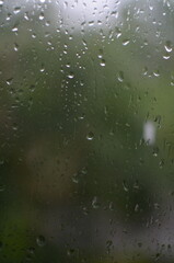 Rain drops on window, blurred background