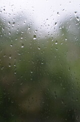 Rain drops on window, blurred background