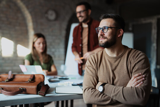 Portrait of entrepreneur in office room looking at camera