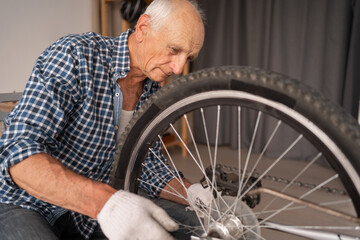 Senior man adjusting wheel bicycle. cycling hobby, bike repair, diy maintenance