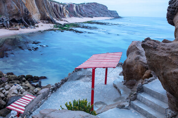 Red and White Beach Shelter Overlooking Cliffs and Shoreline in Santa Cruz, Torres Vedras, Portugal