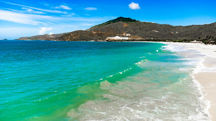 Tropical Beach with Crystal Clear Water and Mountains