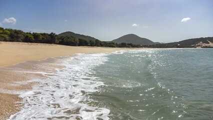 Tropical Beach with Crystal Clear Water and Mountains