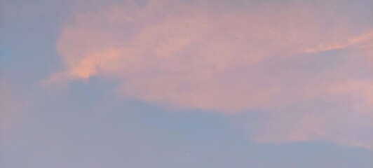 Beautiful sunset sky background with pastel color clouds. Sunset with dramatic sky.