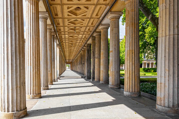 Historic colonnade with classical stone pillars. Symmetrical view of an ancient-style colonnade...