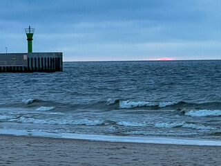 The beach and Baltic Sea near the entrance to the port in Mrzezyno in Poland