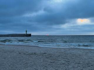 The beach and Baltic Sea near the entrance to the port in Mrzezyno in Poland