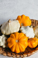 Autumn composition for Thanksgiving Day with variety of pattypan squashes on white kitchen table.