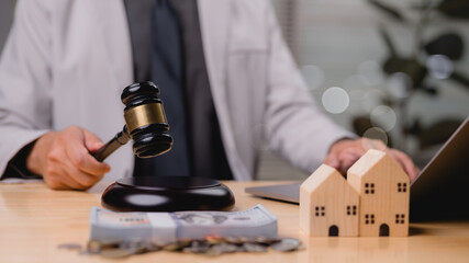 Real Legal Finance Gavel Close Up With Lawyer, Money, And Wooden Home Models For House Deals