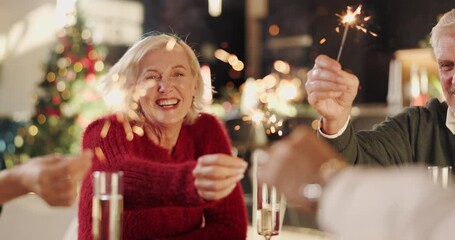 Sparklers, smile and family in home for christmas celebration, event or gathering together. Happy, holiday and people with handheld fireworks for xmas party, dinner or festive season at house.