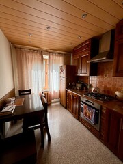 Traditional Kitchen Interior with Wooden Cabinets and Dining Table