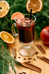 Festive mulled wine with citrus clove and cinnamon garnish on a wooden table