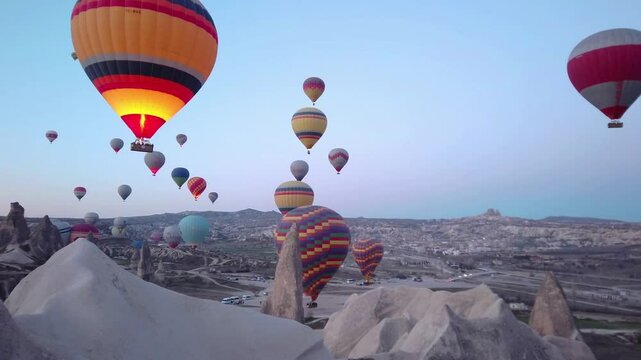 Hot air balloons dot the sky over cappadocia at sunrise
