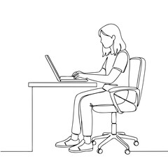 Young woman working on laptop while sitting at desk indoors  