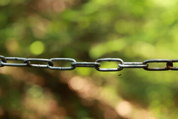 Chain link fence with a chain hanging from it