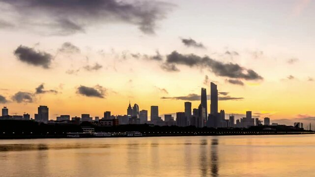 The city skyline reflects in the water at dusk in nanjing, china