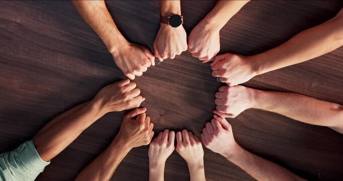 Circle, fist bump and business people in office with collaboration, solidarity and synergy. Top view, teamwork and group of corporate employees with hands together for partnership, unity and goals.