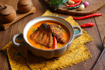 bowl of smoked fish cooked in spicy curry named mangut in Bahasa 