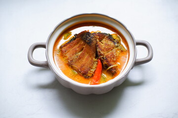 bowl of smoked fish cooked in spicy curry named mangut in Bahasa 