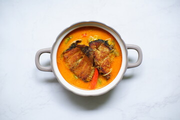 bowl of smoked fish cooked in spicy curry named mangut in Bahasa 