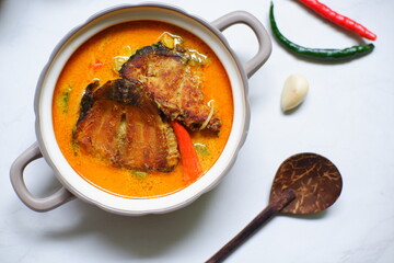 bowl of smoked fish cooked in spicy curry named mangut in Bahasa 