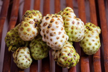 Exotic Noni Fruits Beautifully Arranged on a Rustic Wooden Surface for an Appealing Look