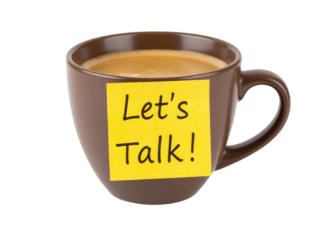 A brown coffee cup filled with coffee has a yellow sticky note on it that says "Let's Talk!".