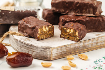 Chocolate peanut protein bars with dates on wooden board