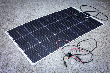 Flexible Solar Panel with Cables on Concrete Surface – Renewable Energy Technology