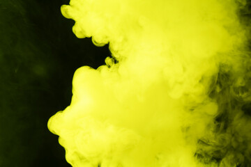 Hookah smoke in yellow light on black background, closeup