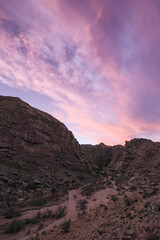 Sunset over an arid canyon with pretty clouds