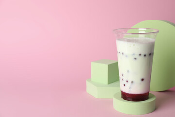 Tasty refreshing bubble tea on pink background. Space for text