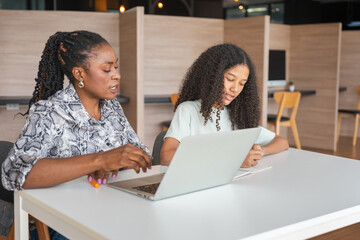 Mother and Daughter Studying Together with Laptop, Female Tutor Helping Teenage Student with...