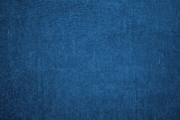 Deep blue textured background. Embossed wall with blue tones