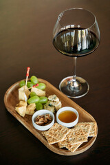Elegant wine and cheese platter with grapes crackers nuts and honey