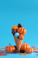 A colorful and bright creative layout featuring an ice cream cone filled with autumn leaves and a small pumpkin — a playful blend of fall and fantasy.