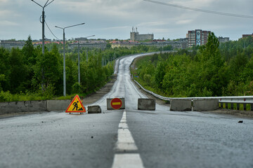 closed road with city in the background