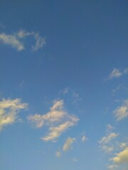 The bright blue sky stretched out with scattered white clouds, illuminated by the sunlight that looked so beautiful.
